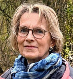 Monika ist eine von drei Peer-Berater*innen der BVSS Portraitfoto einer Frau in den Fünfzigern; blondes, mittellanges Haar, Brille und Halstuch